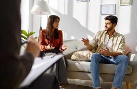 young family couple at psychologist counseling meeting